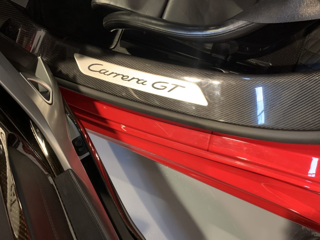 2005 Porsche Carrera GT | Guards Red / Dark Grey. 3,800 miles from new.